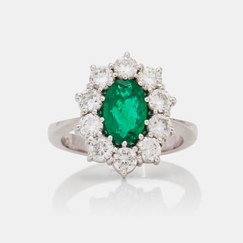 1195. A circa 1.00ct emerald and brilliant-cut diamond ring.