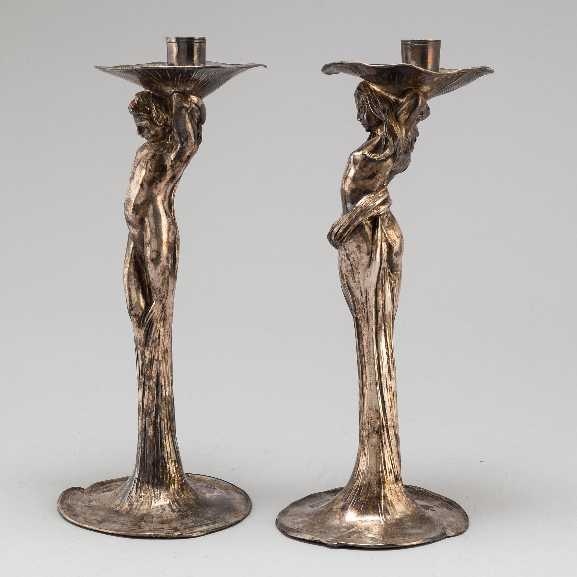 A 20th Century pair of art noveau style candle sticks marked A.W.OX.