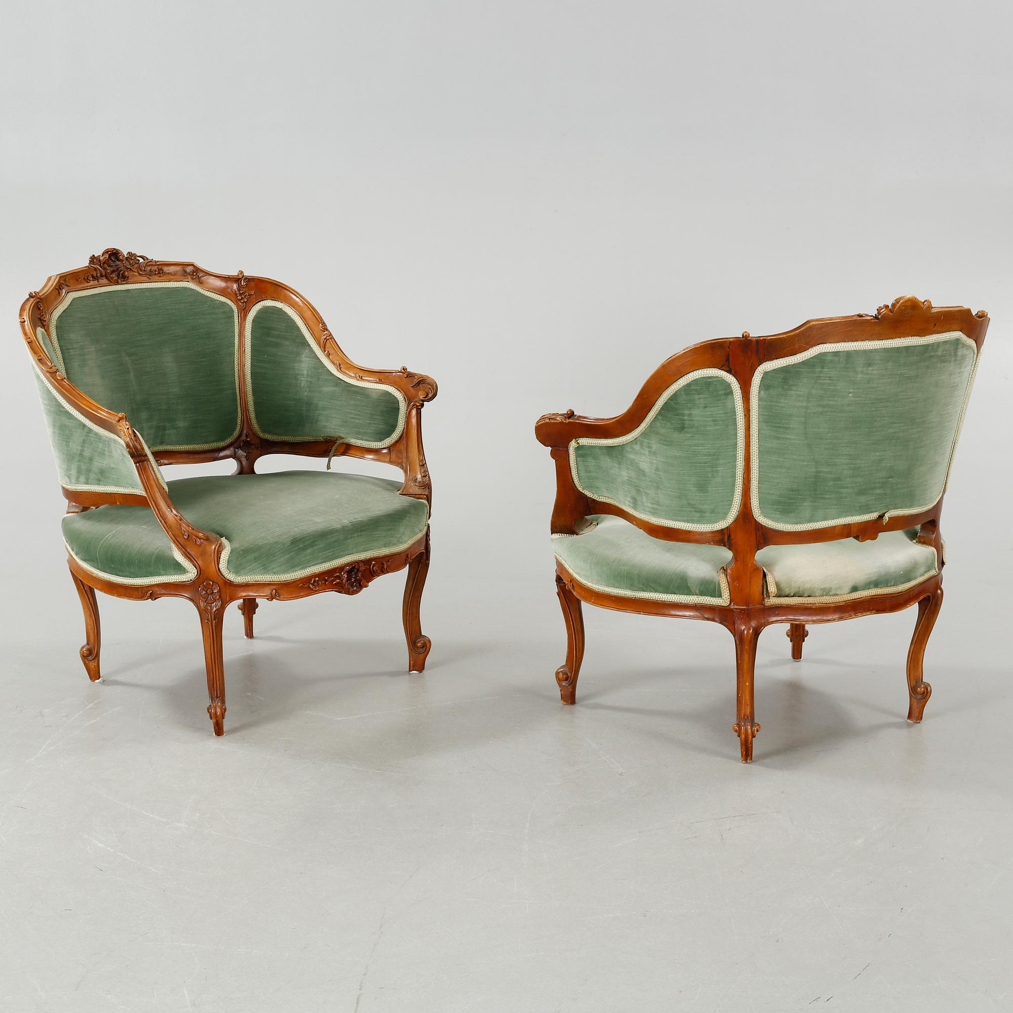 A rococo style sofa, two lounge chairs and a table, around the year 1900 and first half of the 20th century.