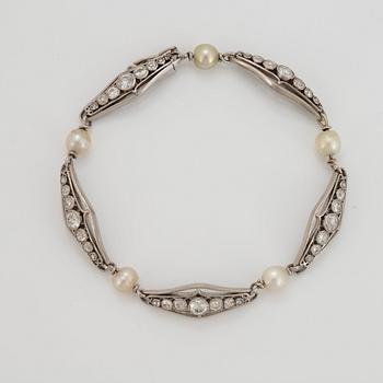 A platinum bracelet set with old-cut diamonds and pearls.