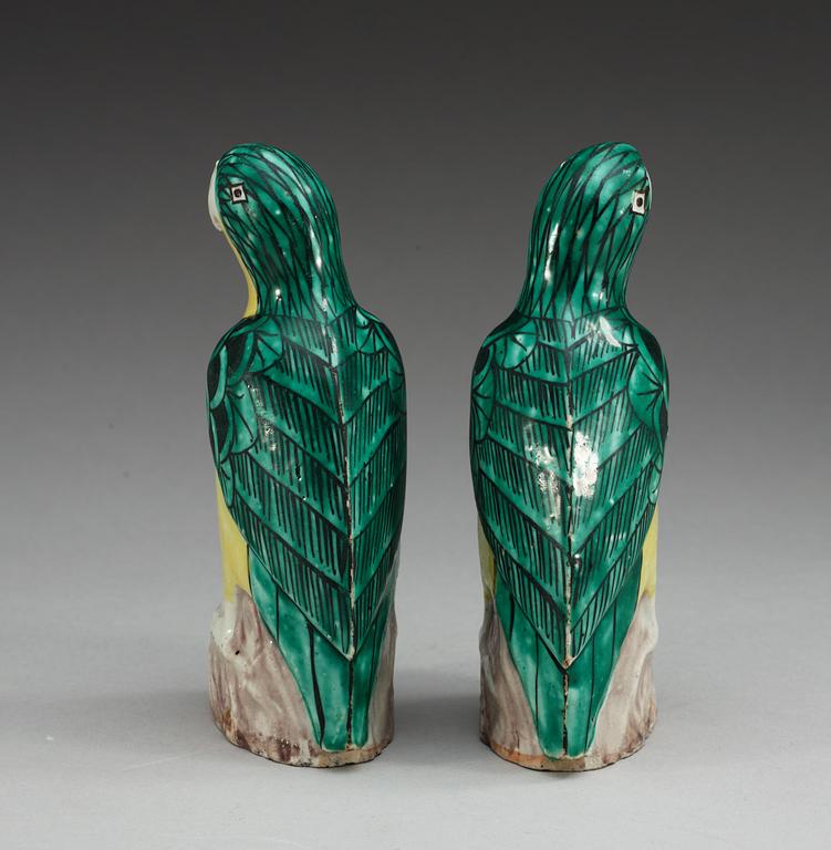 A pair of two green and yellow glazed parrots, Qing dynasty, Jiaqing (1796-1820).