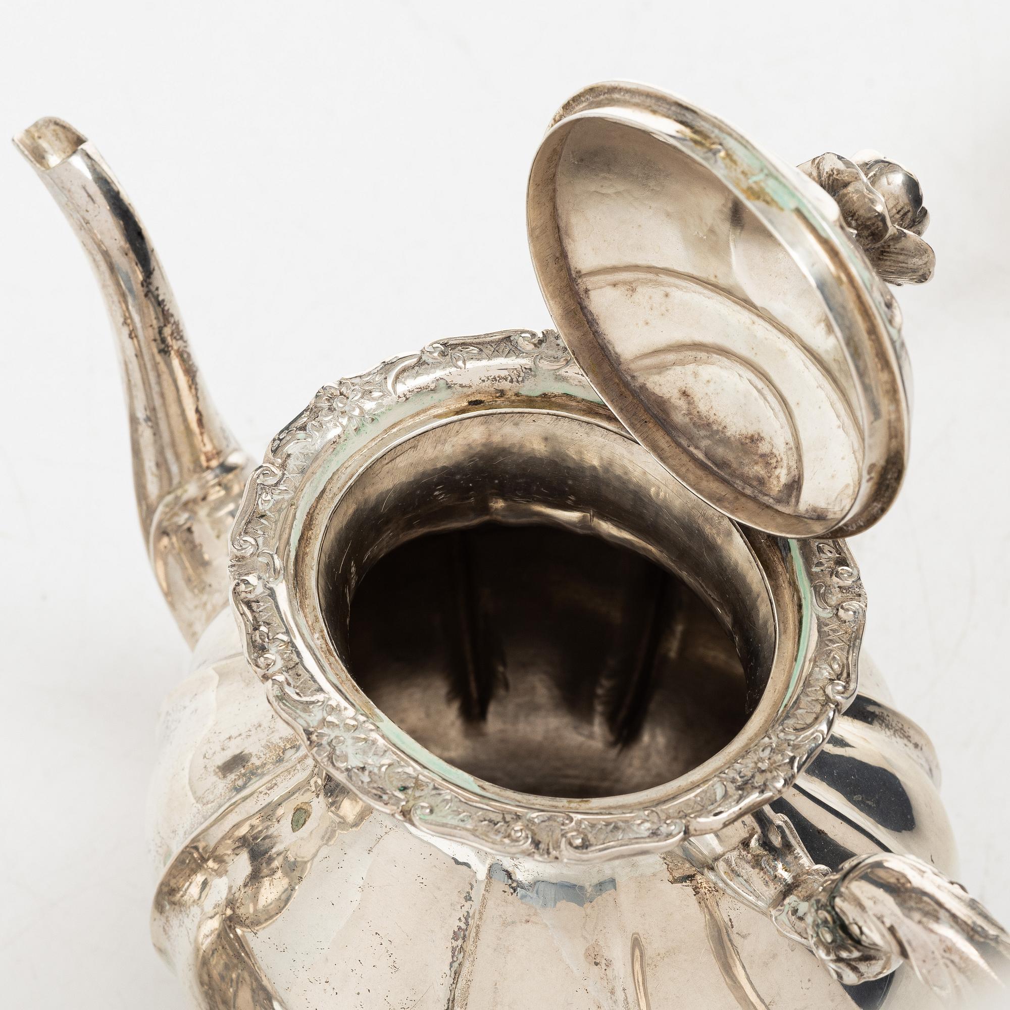 A Rococo style silver coffee pot, cream jug and sugar bowl, 20th century, Swedish import mark.