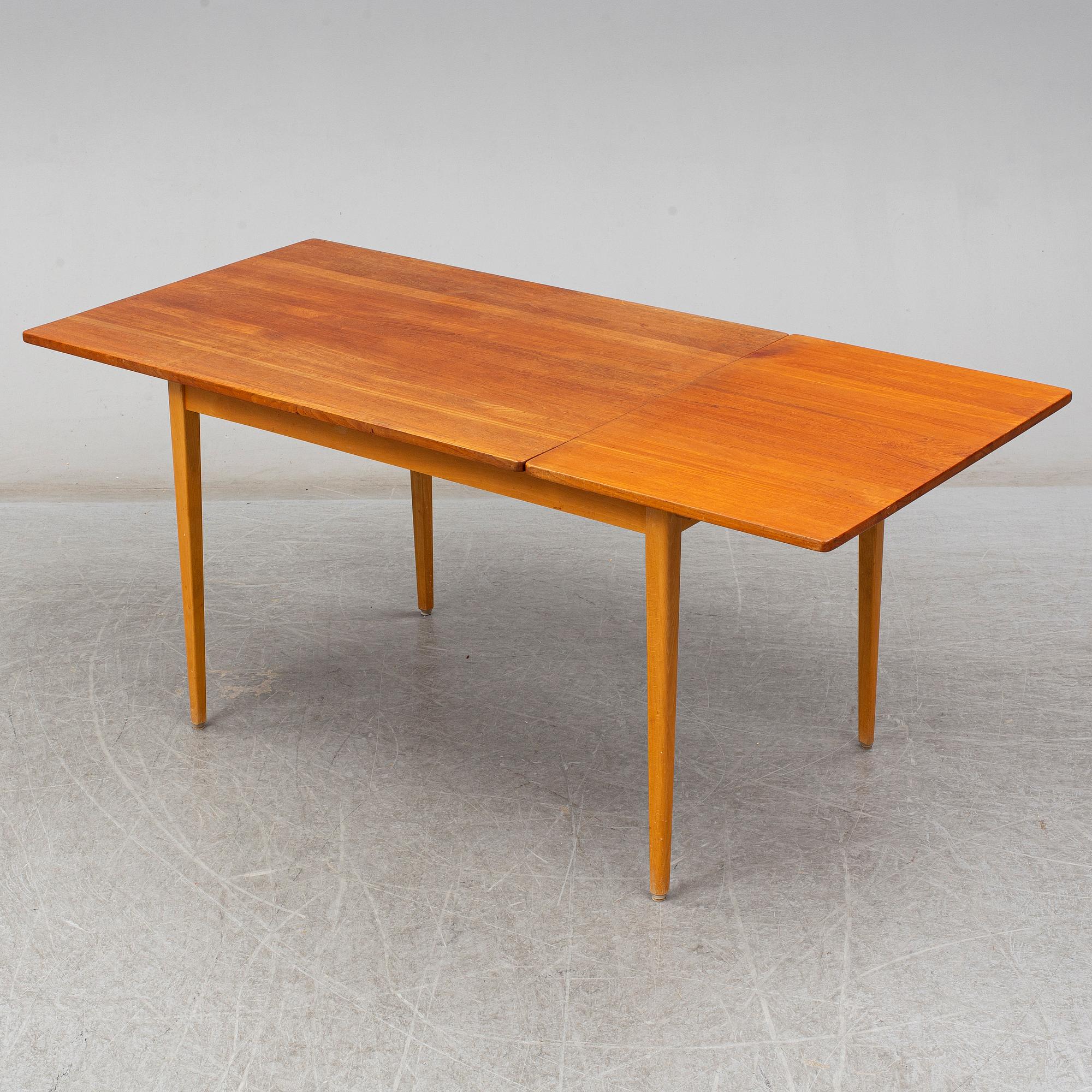A 1960s teak veneered dining table.