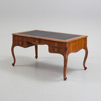 a mahogany rococo-style desk from the second half of the 19th century.