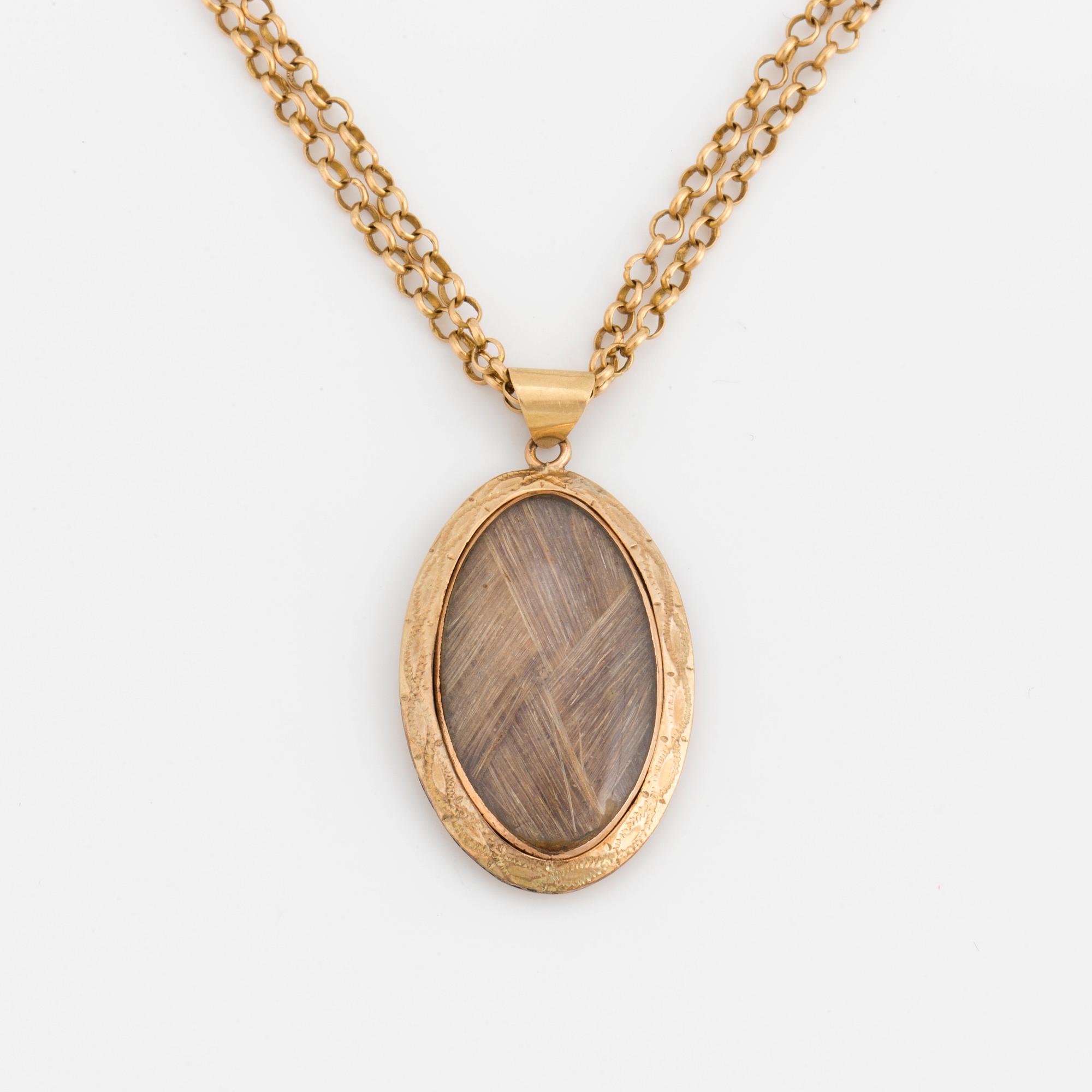 A chain and locket with hairwork.