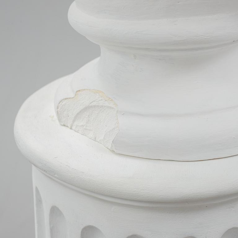 A plaster bust and pedestal.