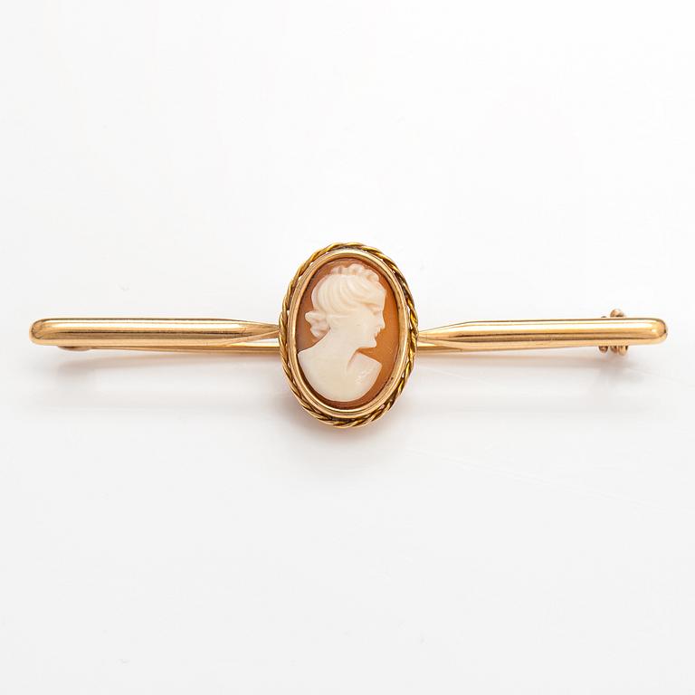 Two brooches and a ring, 14K and 18K gold and sea shell cameos.