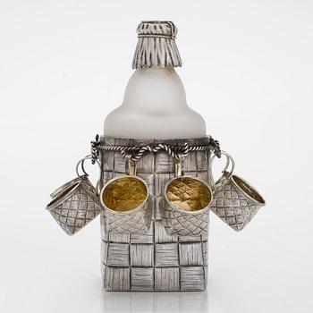 A silver and glass bottle with eight silver charka, maker marks of Pyotr Yermolajevich Davidov, Saint Petersburg, 1884.