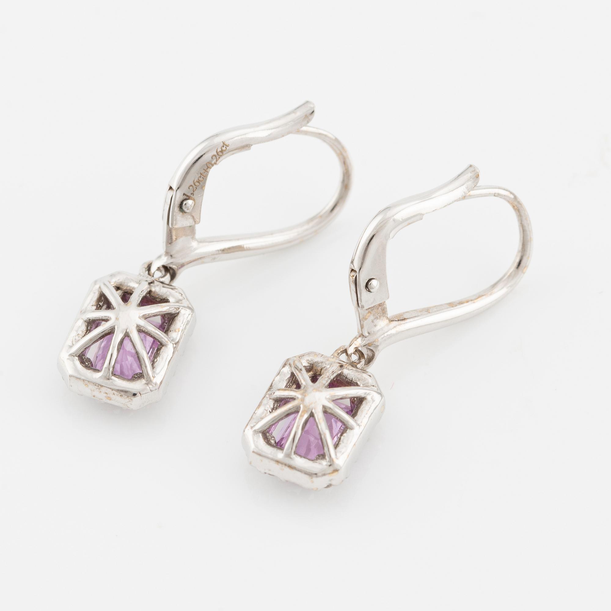 A pair of earrings in 18K white gold with pink sapphires and round brilliant-cut diamonds.