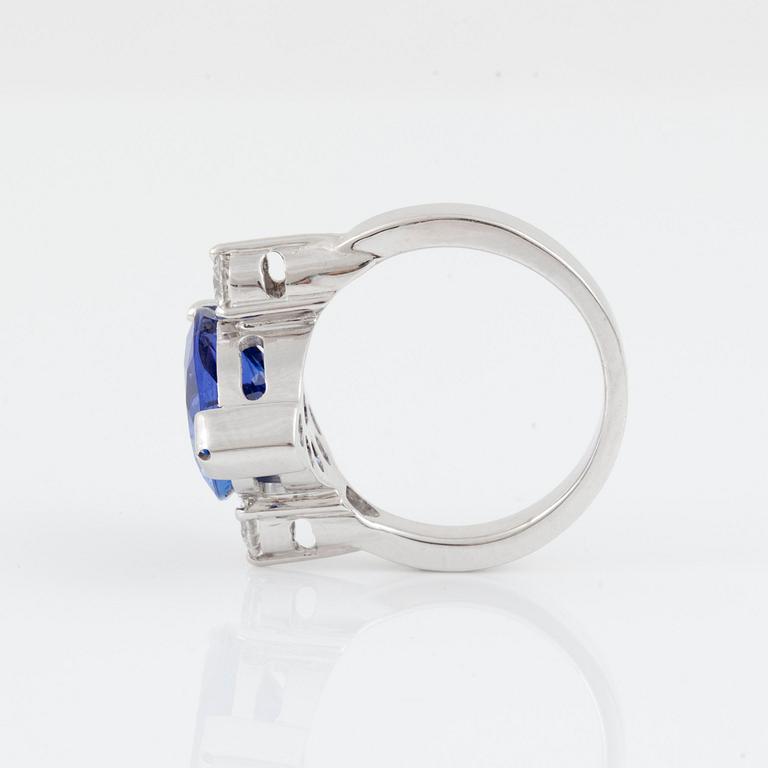 A pear-shaped tanzanite and brilliant-cut diamond ring. Total carat weight of diamonds 0.40 ct.