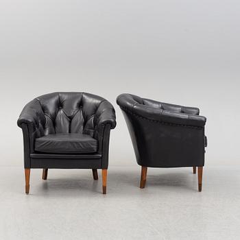 A pair of leather upholstered easy chairs, second half of the 20th Century.