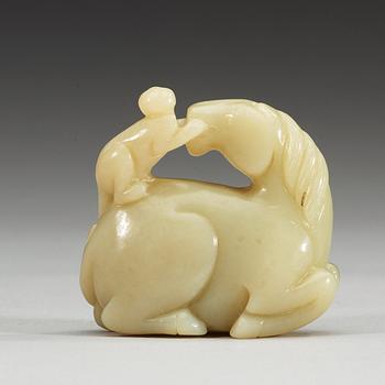 A nephrite figure of a reclining horse with a monkey, China.