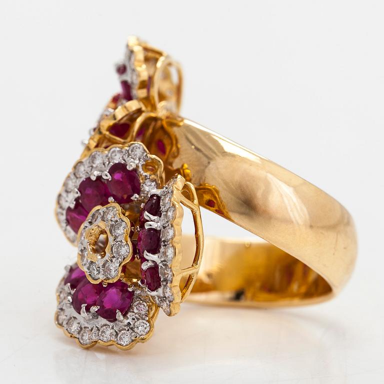 An 18K gold flower ring, with rubies and brilliant-cut diamonds totalling approximately 0.82 ct.