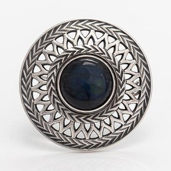 A sterling silver brooch with a spectrolite, model 287. Kalevala Koru, Helsinki 1981.