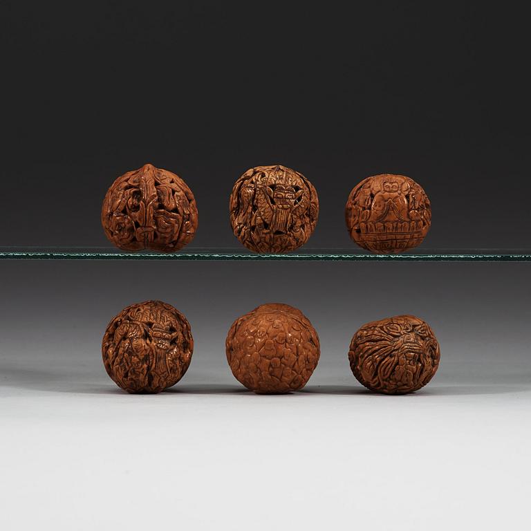 A set of six carved walnut hand exercisers, late Qing dynasty (1644-1912).