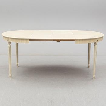A set of eight chairs and a dining table. Gustavian style, second half of the 20th century. 2 leaves included.