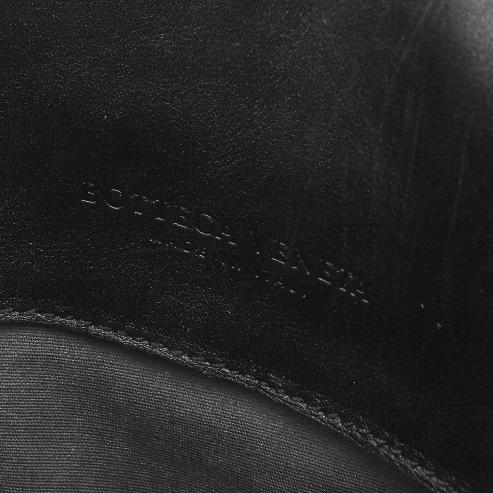 Bottega Veneta, a black intrecciato leather briefcase.
