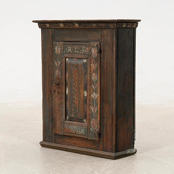 Wall-mounted cabinet dated 1804.