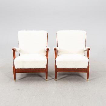 A pair of 1940s cheepskin armchairs.