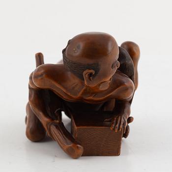 A Japanese mei boxwood okimono of a rat catcher. Meiji period.