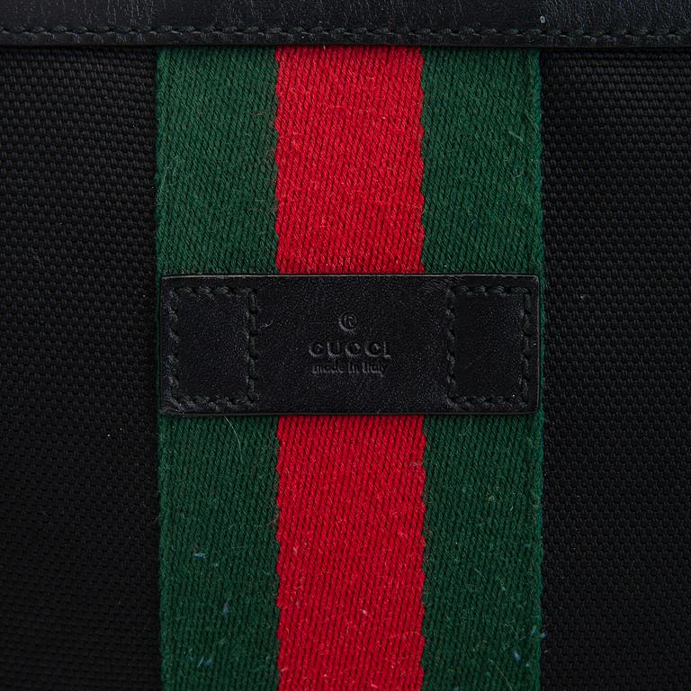 Gucci, a "Techno Canvas Web Messenger" bag.