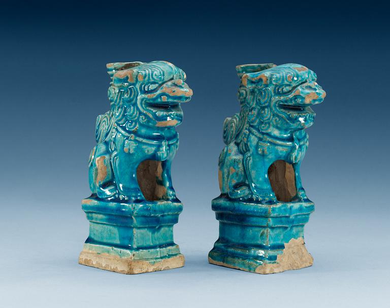 A pair of turquoise glazed censers in the shape of seated fable figures, Ming dynasty (1368-1644).