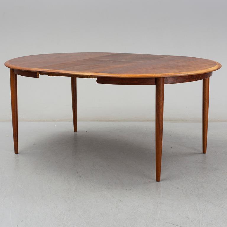 KURT ØSTERVIG, a teak dining suite with a round table and six chairs, Brande Möbelindustri, Denmark.