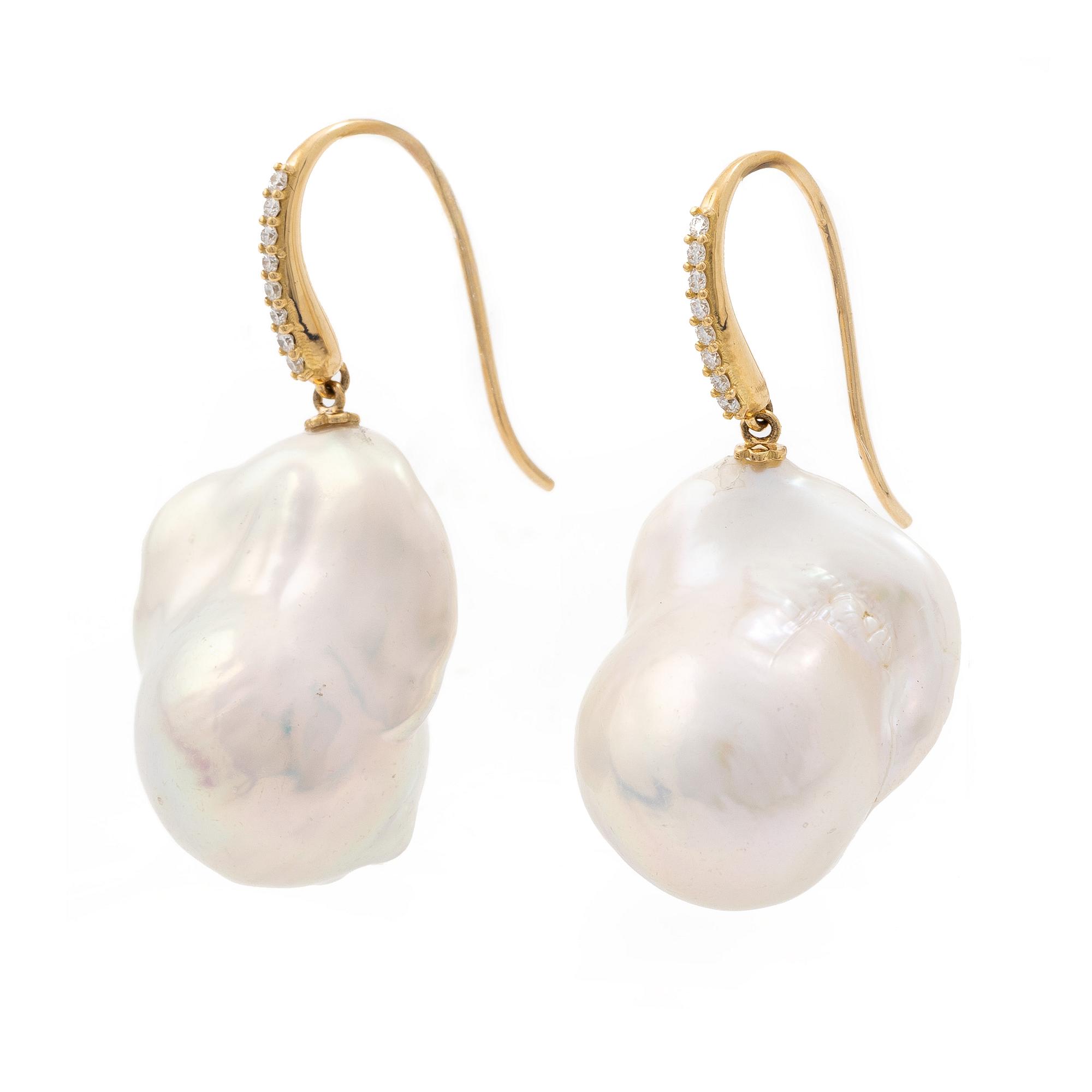 A pair of earrings with cultured baroque-shaped freshwater pearls and round brilliant-cut diamonds.