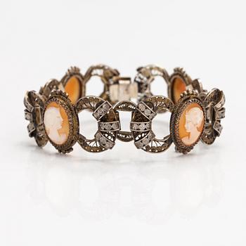 A silver and sea shell cameo bracelet.