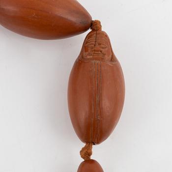 A necklace with sculptured nuts, circa 1900.