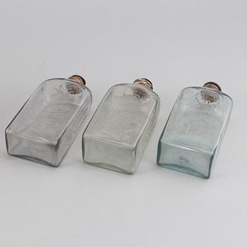 A late Empire mahogany box with three glass bottles, mid 19th Century.