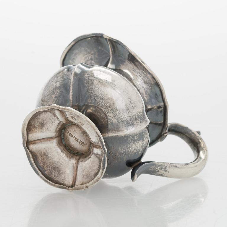 A silver cream jug, maker's mark of Michael Takkinen, St. Petersburg 1856.