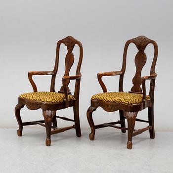 A pair of oak baroque style armrest chairs, 1920s.