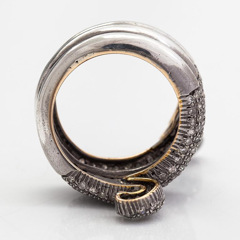 A serpent ring in gold and silver with rubies and single cut diamonds ca 0.88 ct in total.