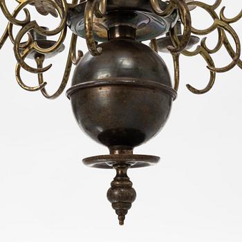 A Baroque style brass chandelier from around the year 1900.