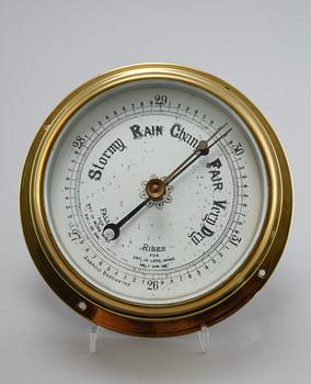 A wall clock from Smith Empire and a barometer, made in the fourth quarter of the 20th century.