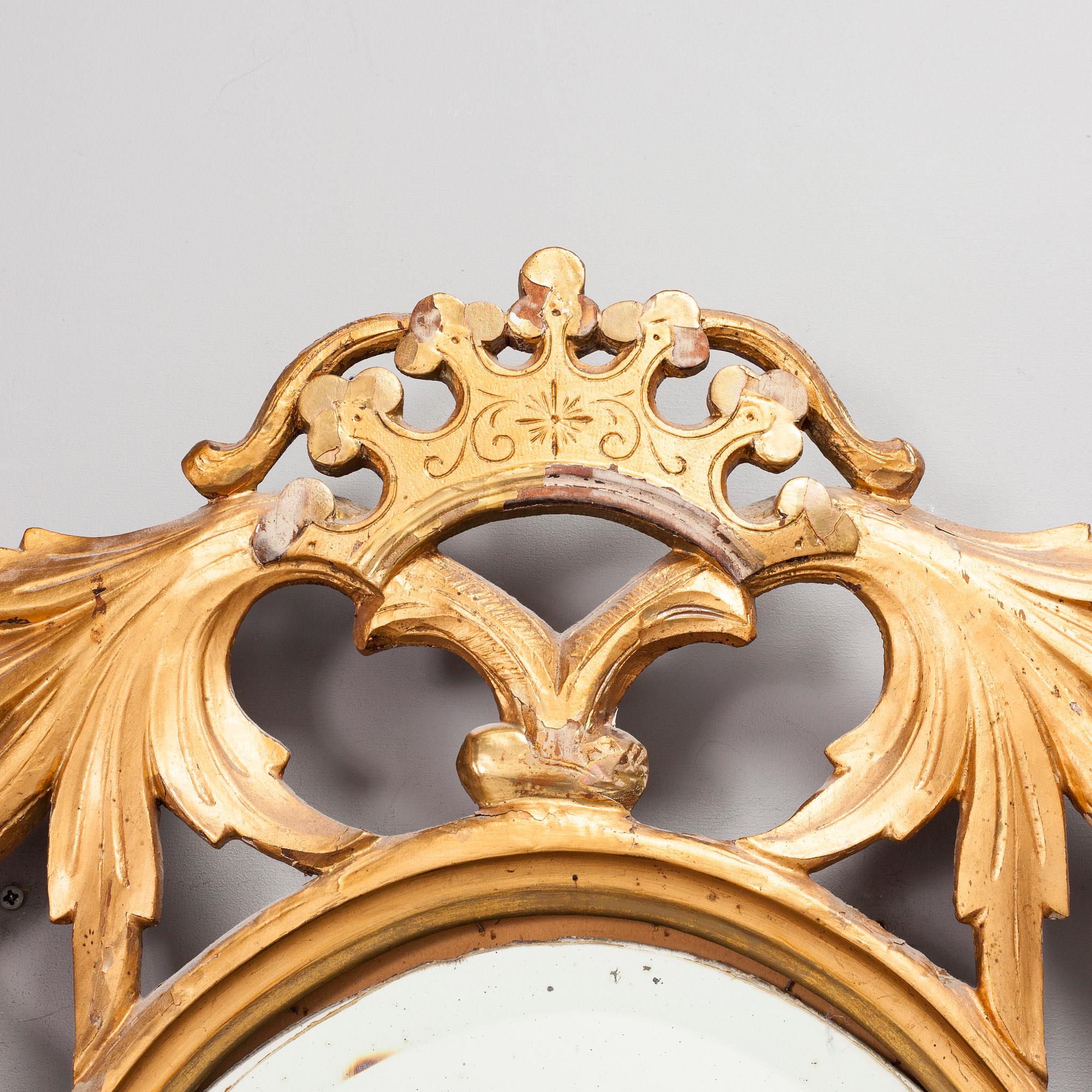 A gilded and bronzed woodcut leaf decorated mirror, second half of the 19th century.