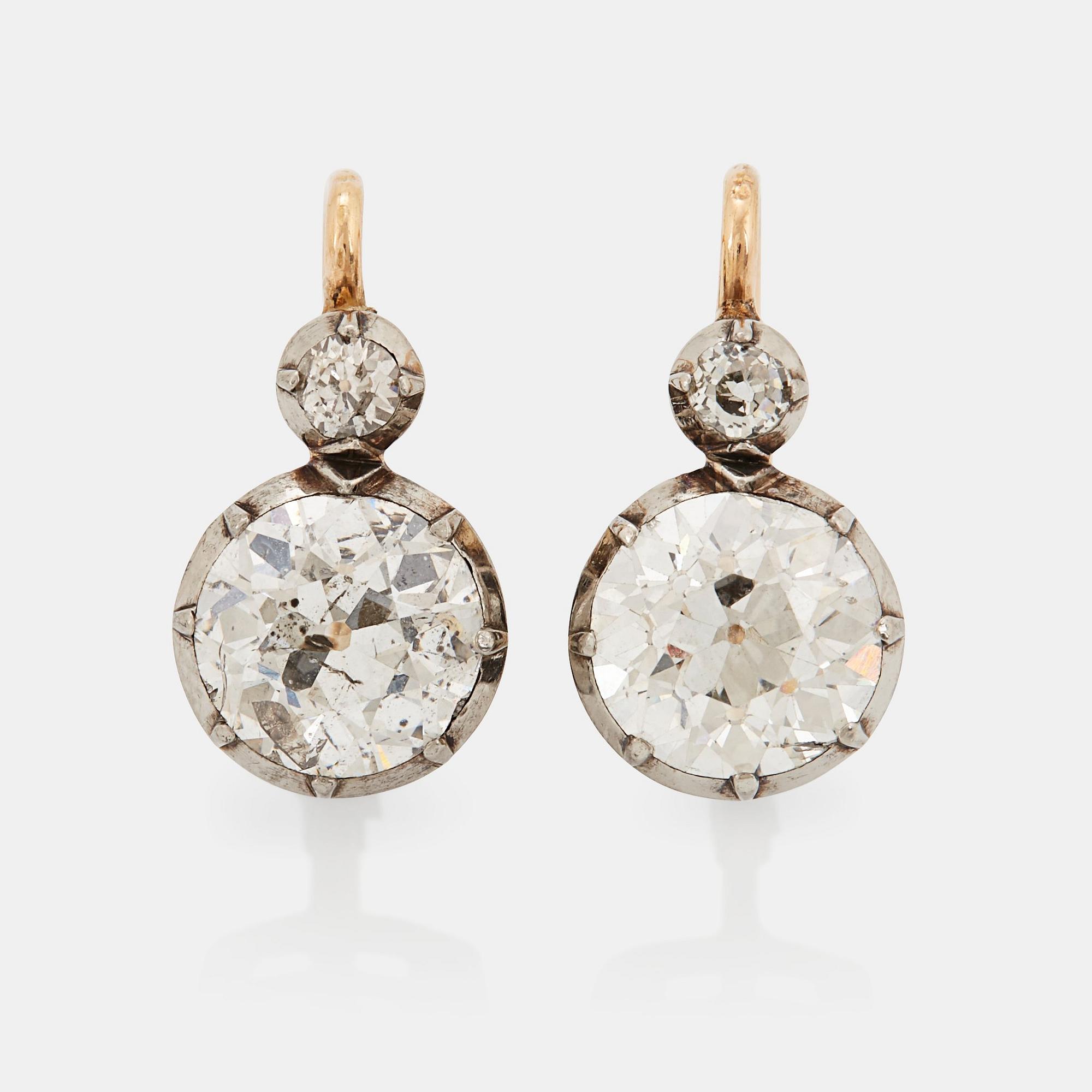 A pair of 14K gold earrings set with old-cut diamonds with a total weight of ca 2.50 cts.
