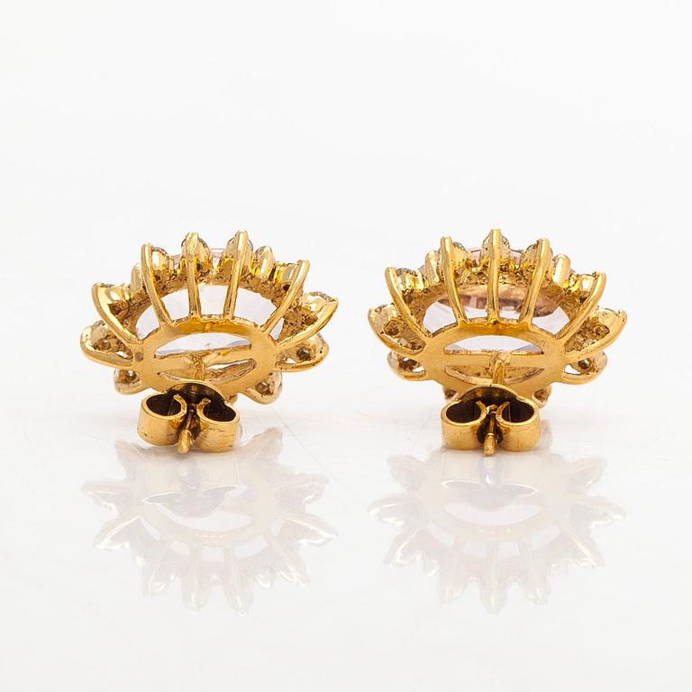 A pair of 14K gold earrings with faceted morganites and brilliant-cut diamonds.