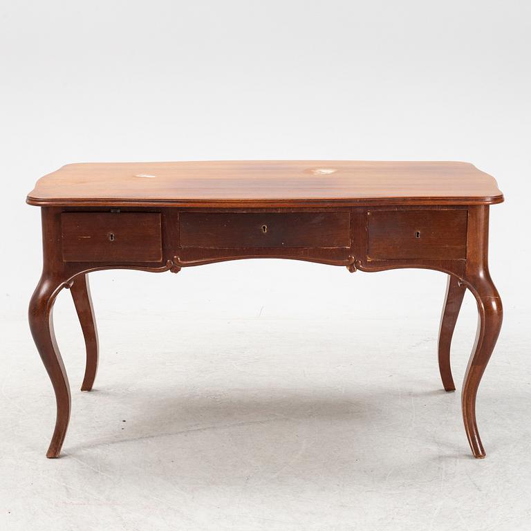 A mahogany Rococo revival desk, late 19th Century.