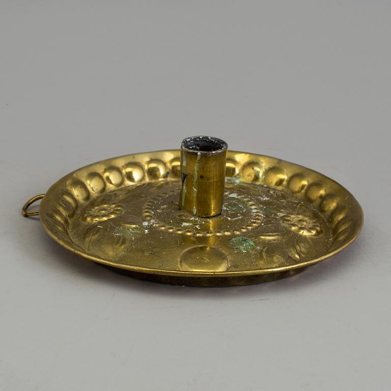 A BRASS CANDLESTICK and a GRATER, 18th century.