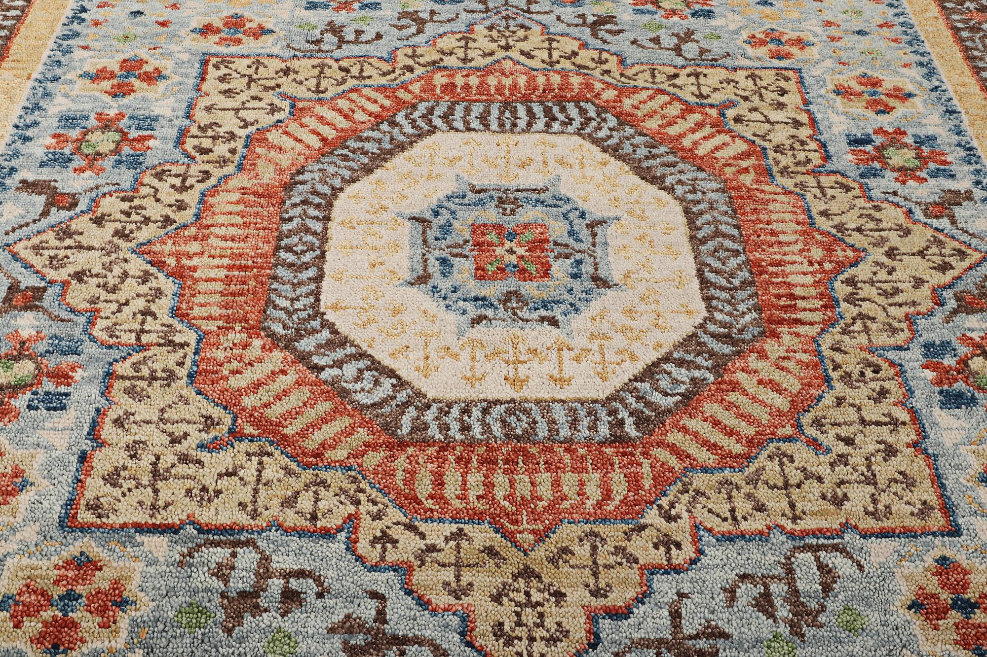 An oriental carpet with Mamluk design, c. 356 x 255 cm.