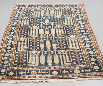 A RUG, a semi-antique West Persian, ca 239-247 x 140,5-147,5 cm (as well as ca 3 cm flat weave at the ends).
