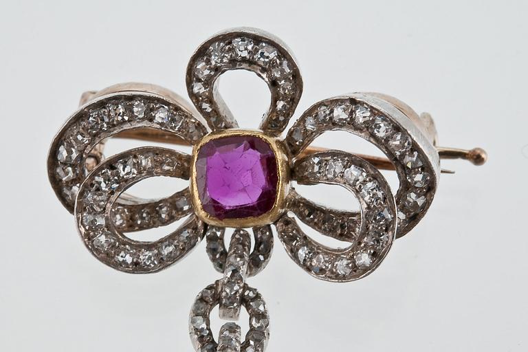 A DIAMOND AND RUBY BROOCH.