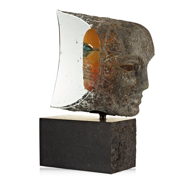 A Bertil Vallien sand cast sculpture of a head, 'Janus Window' on a stone base, Kosta Boda 2006.