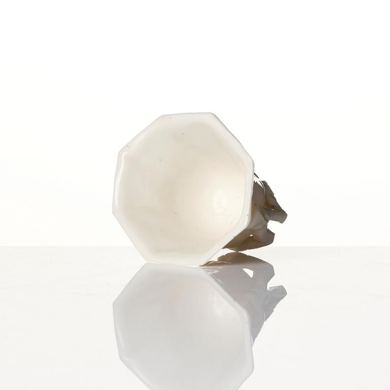 A lacquer tea box and a blanc de chine cup, Qing dynasty 18/19th century.