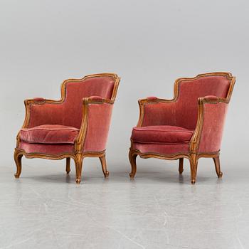 A pair of rococo style easy chairs from around the year 1900.
