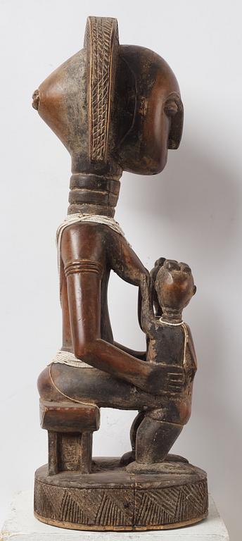 A sculptue and two masks reportedly from The Ivory coast, from the second half of the 20:th century.