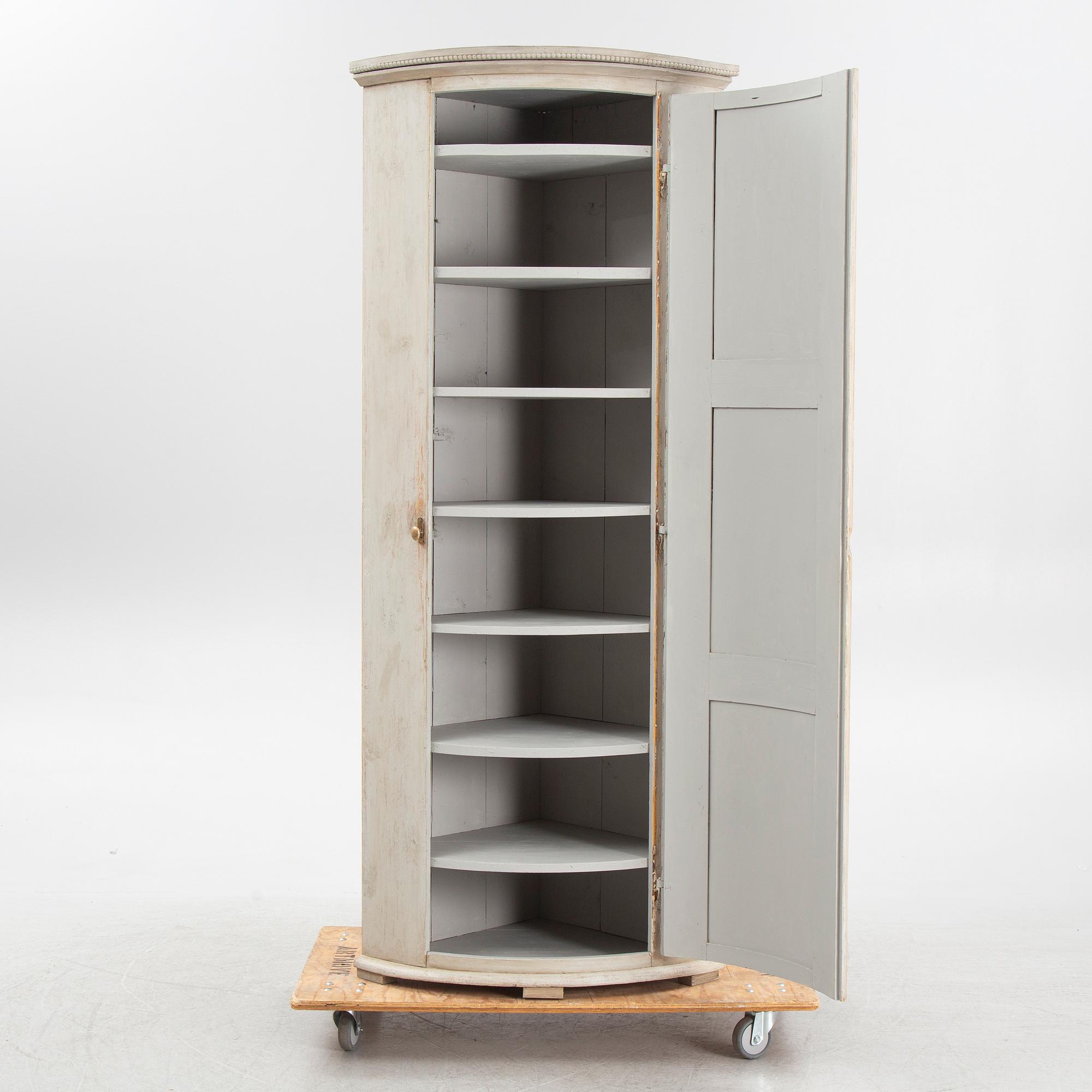 A painted corner cabinet, later part of the 19th Century.