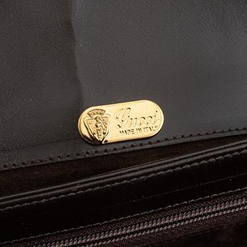 Gucci, a leather and bamboo bag.